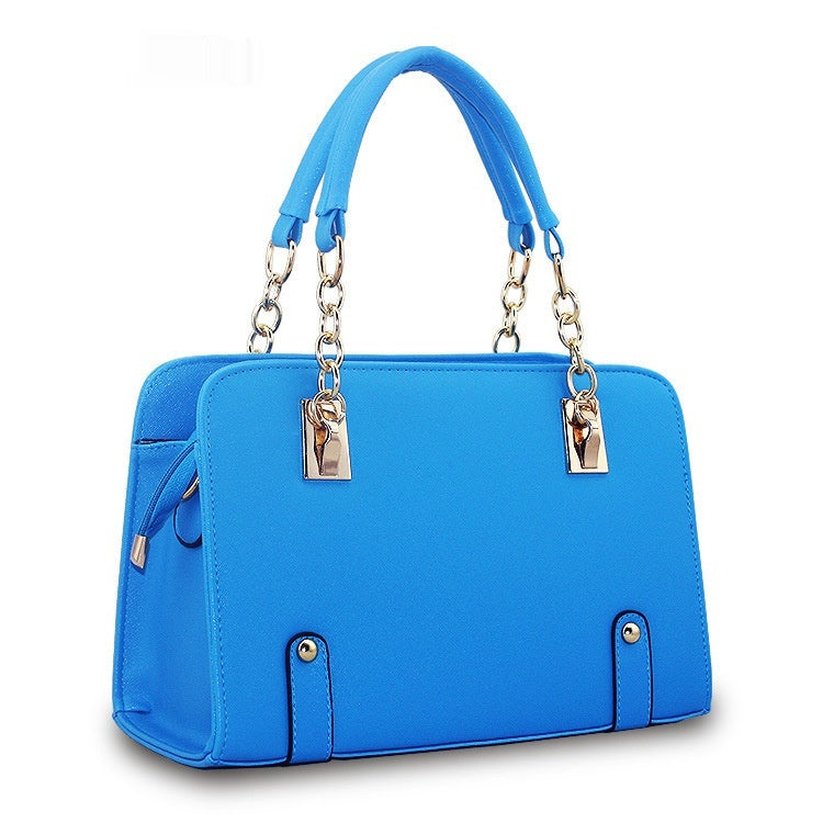 Blue handbag with gold accents on a white background