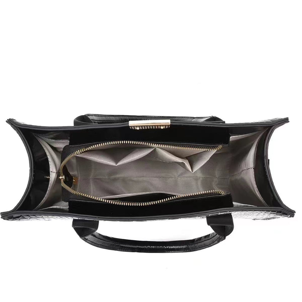 Black handbag with open front compartment on a white background