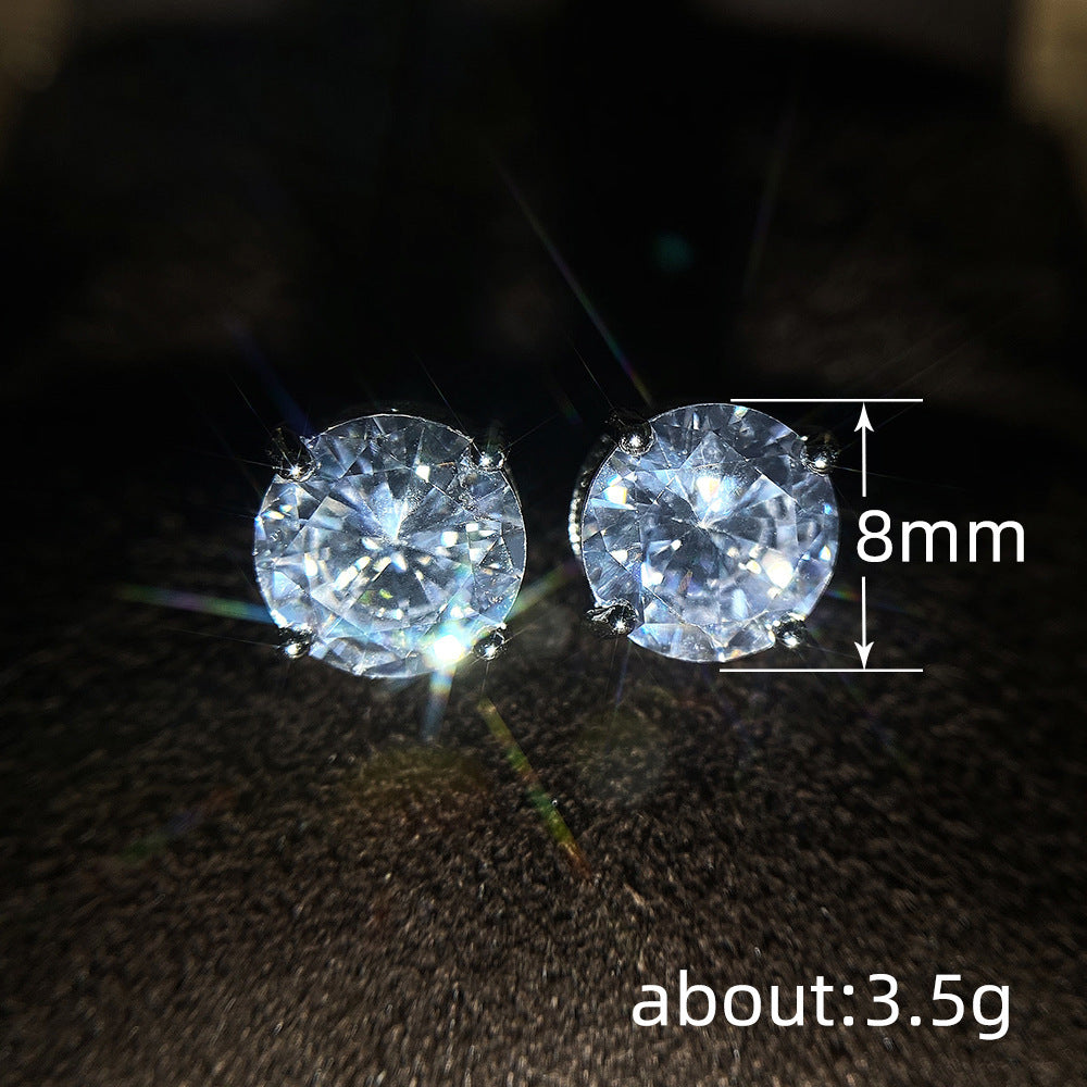 Pair of diamond earrings with a measurement label indicating 8mm diameter and weight of about 3.5g on a dark background.