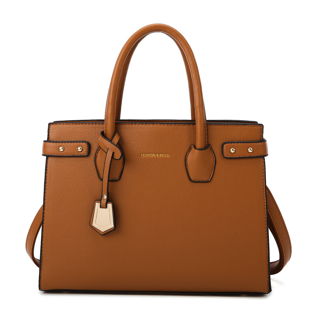 Brown handbag with a strap on a white background