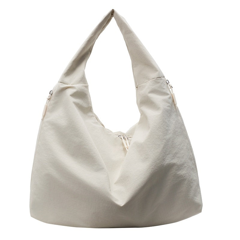 Beige handbag with a strap on a white background