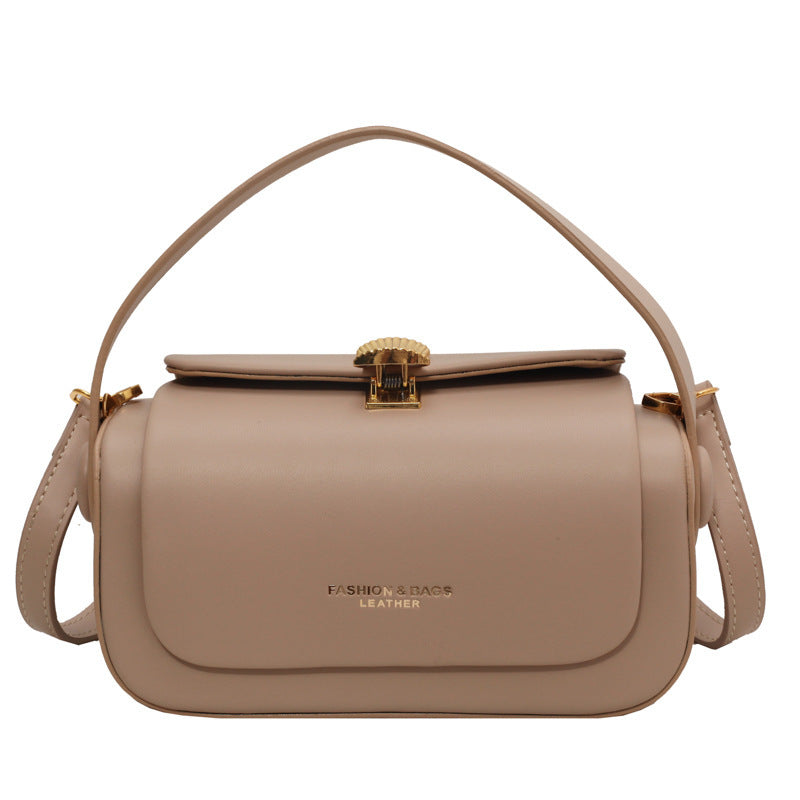 Beige handbag with a gold clasp on a white background