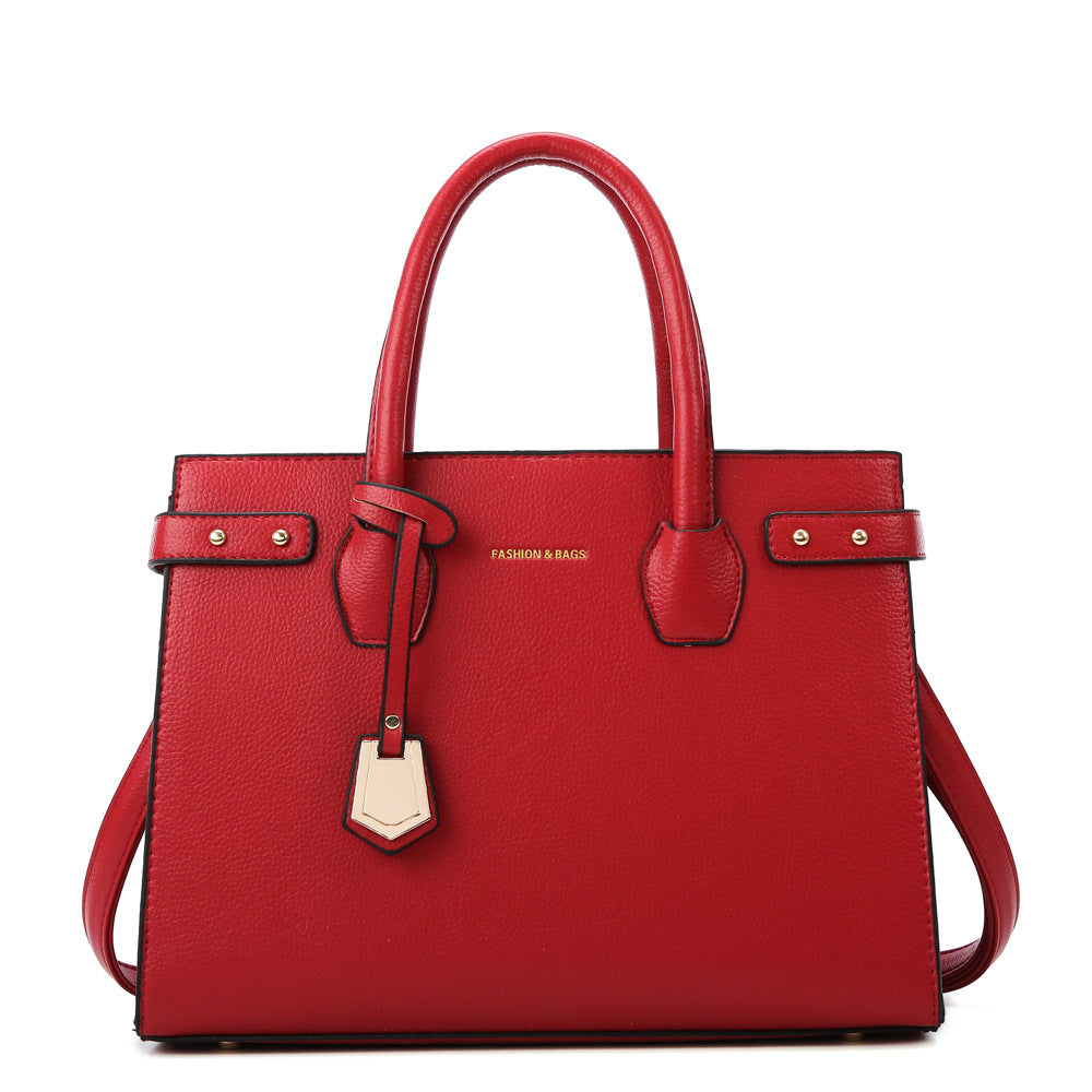 Red handbag with gold accents on a white background