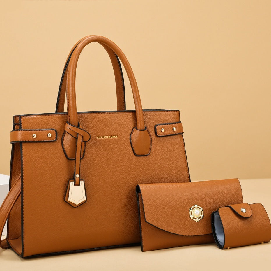 Brown leather handbag and matching wallet on a beige background