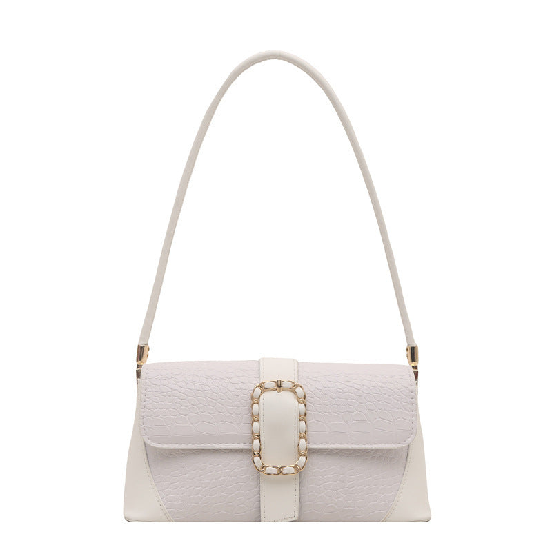 White handbag with a gold buckle on a white background