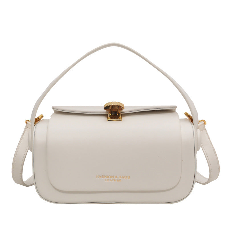 White handbag with gold accents on a white background