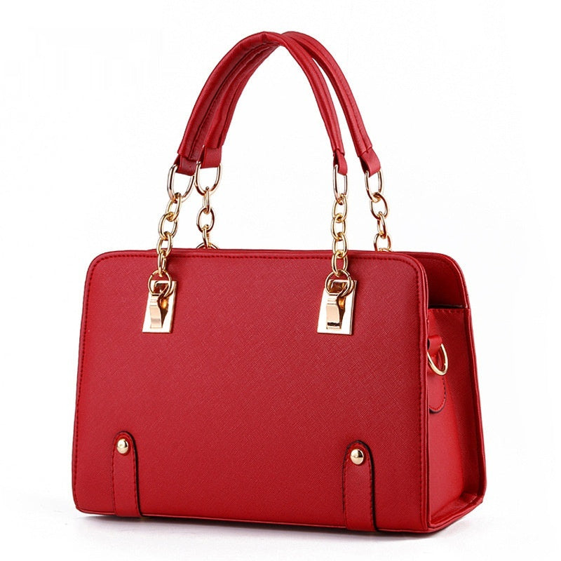 Red handbag with gold accents on a white background