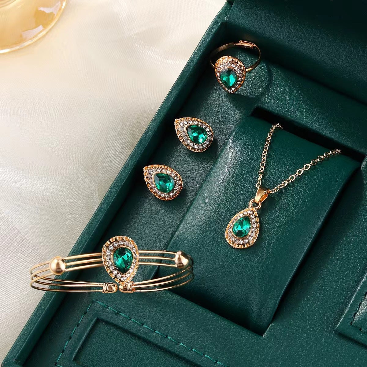 Jewelry set with green gemstones on a green box