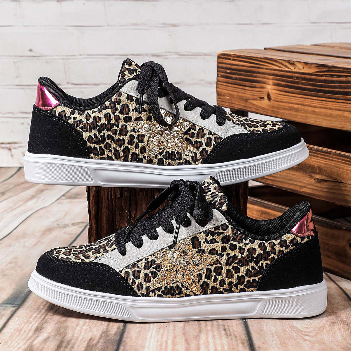 Leopard print sneakers with black and white accents on a wooden surface