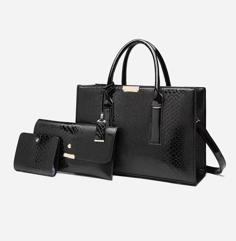 Set of black handbags with a textured pattern on a white background
